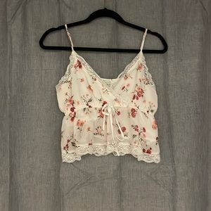 White tank top with red and pink floral design with lace on bottom and top